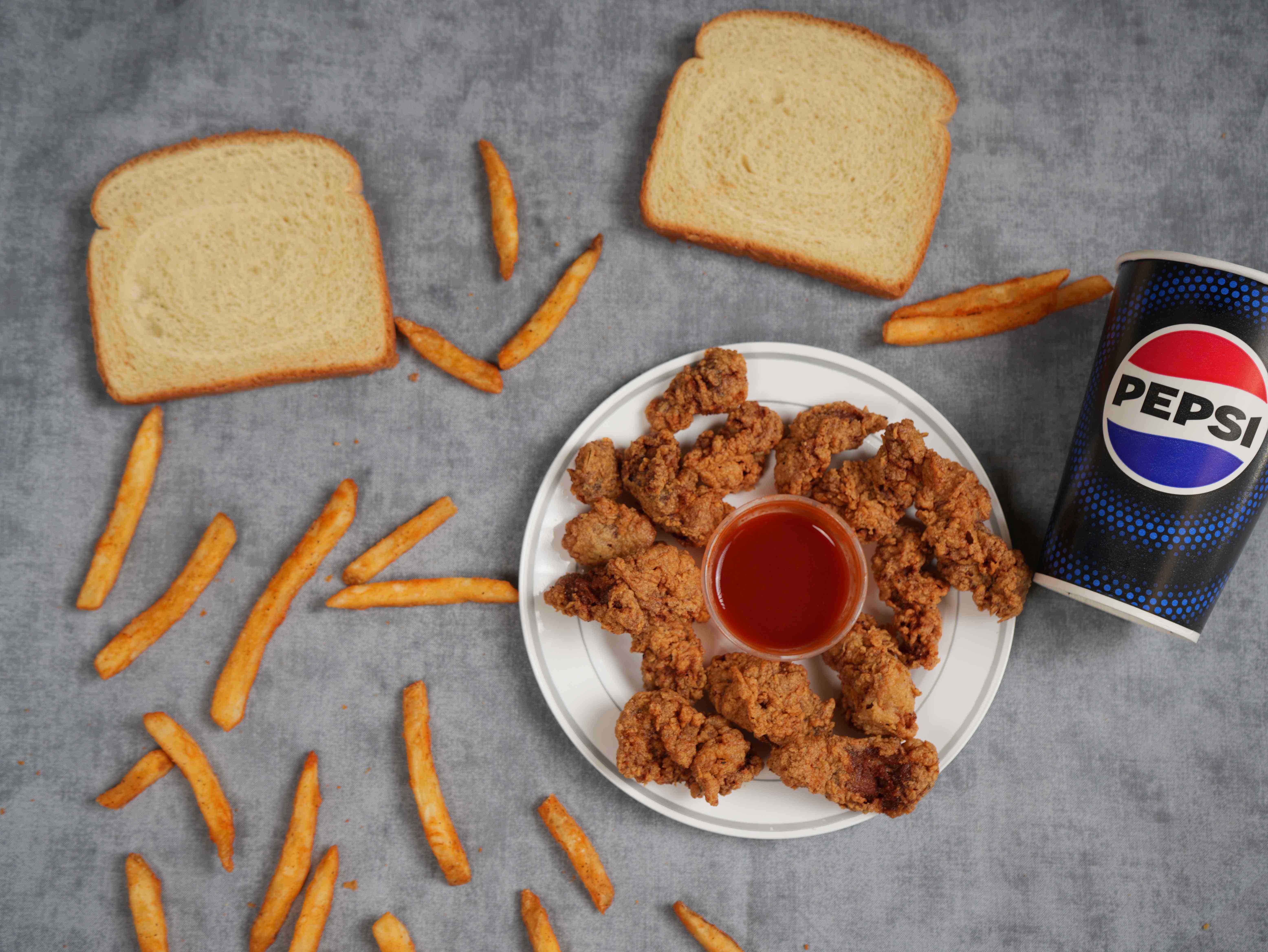 Crispy fried chicken gizzards with fries, bread and Pepsi from J's Fish and Chicken